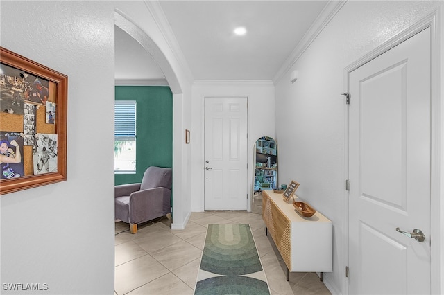 entrance foyer featuring ornamental molding and light tile patterned flooring