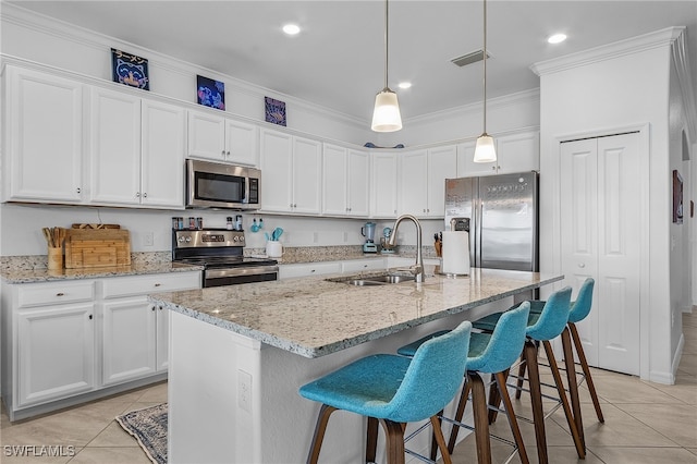 kitchen featuring white cabinetry, stainless steel appliances, sink, and a center island with sink