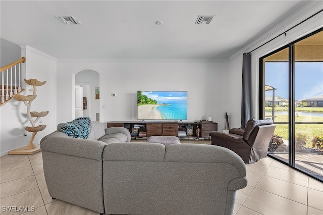 living room featuring ornamental molding and light tile patterned floors