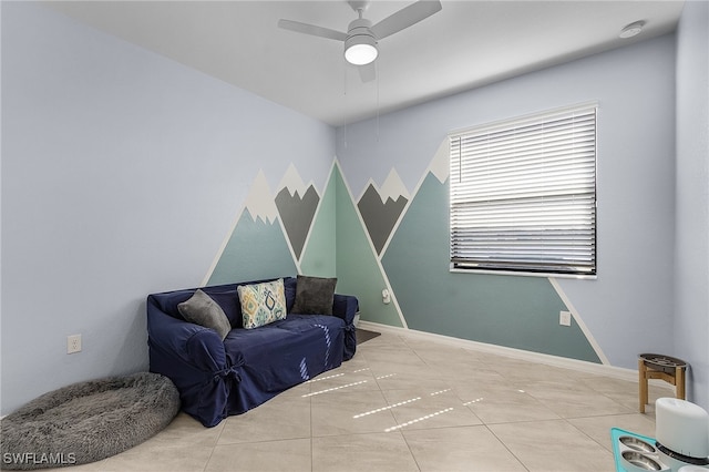 sitting room with ceiling fan and tile patterned flooring