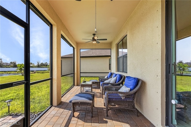 sunroom / solarium featuring ceiling fan