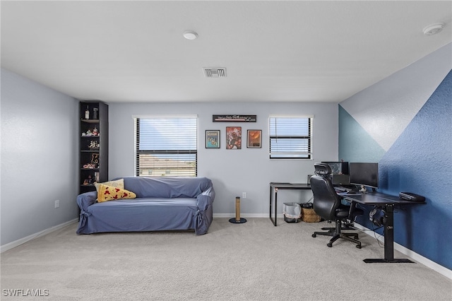 carpeted home office with vaulted ceiling