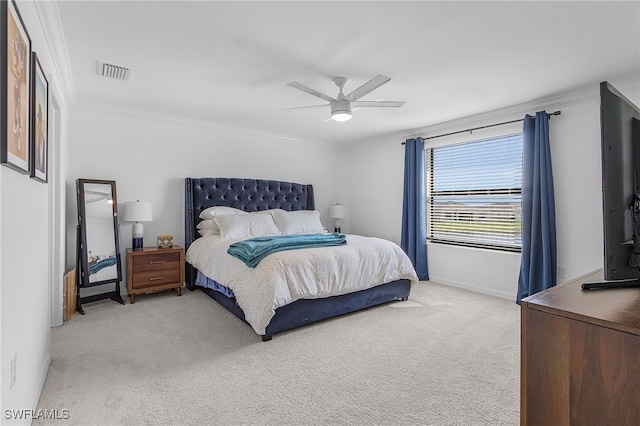 carpeted bedroom featuring ceiling fan and ornamental molding