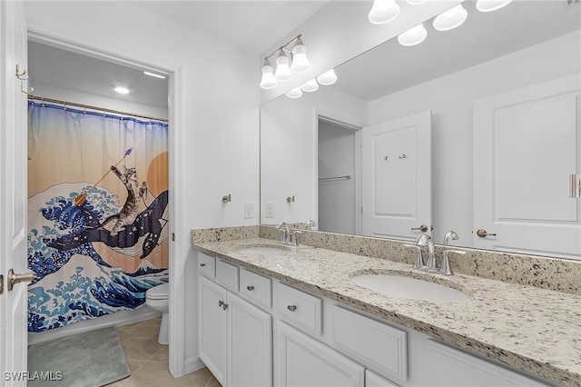 bathroom featuring vanity, toilet, and tile patterned flooring