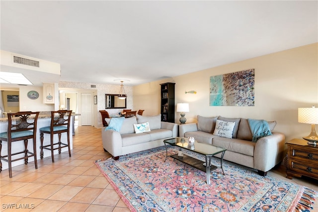 tiled living room with a skylight