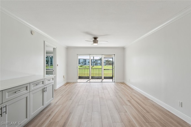 unfurnished living room with light hardwood / wood-style floors, ornamental molding, and ceiling fan