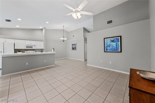 unfurnished living room featuring ceiling fan with notable chandelier, light tile patterned floors, and high vaulted ceiling