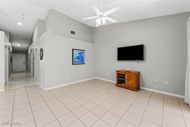 unfurnished living room featuring light tile patterned floors and ceiling fan