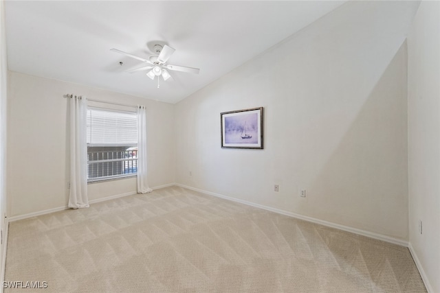 carpeted empty room featuring ceiling fan and vaulted ceiling