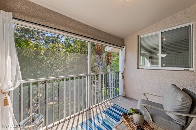 sunroom / solarium featuring lofted ceiling