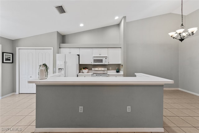 kitchen with hanging light fixtures, lofted ceiling, white appliances, and a spacious island