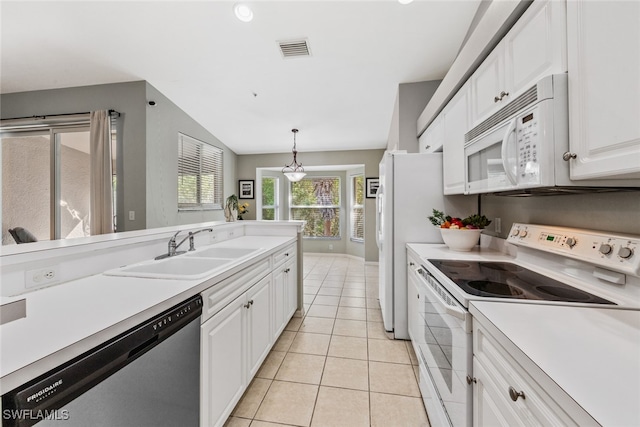 kitchen with white cabinets, hanging light fixtures, sink, white appliances, and vaulted ceiling