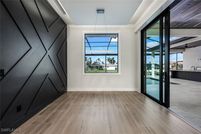 unfurnished room with light hardwood / wood-style floors and a healthy amount of sunlight