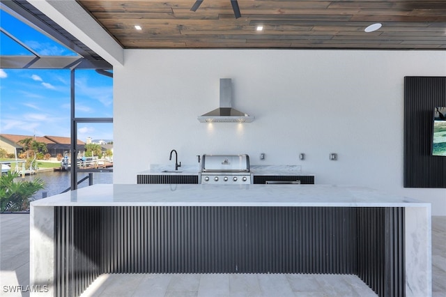 view of patio featuring a water view, a sink, and area for grilling