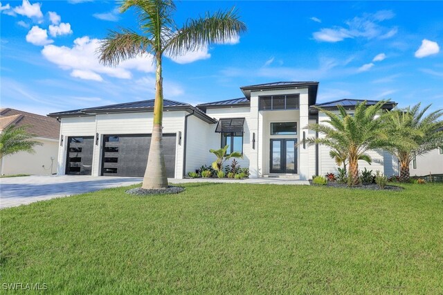 modern home featuring a front lawn and a garage