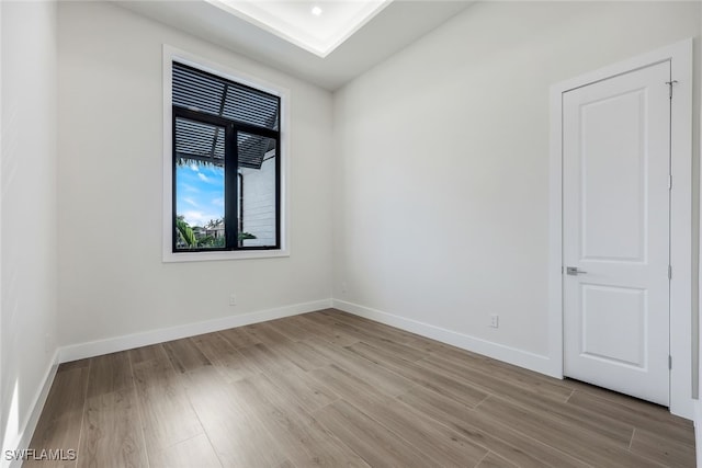 empty room with light wood-style flooring and baseboards