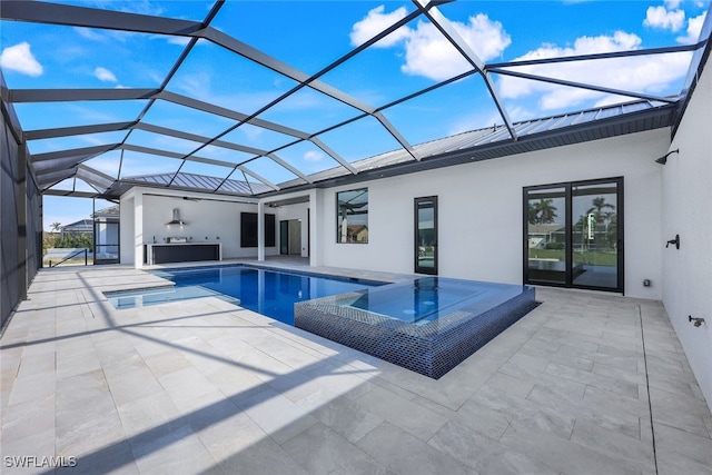 view of swimming pool featuring a patio area, glass enclosure, and a pool with connected hot tub