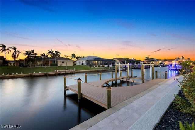 view of dock with a water view and a residential view