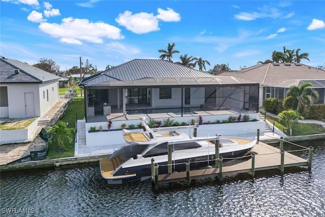 back of property featuring a patio, boat lift, a lanai, a water view, and a pool