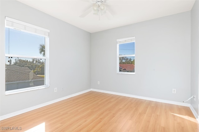 empty room with ceiling fan and light hardwood / wood-style floors