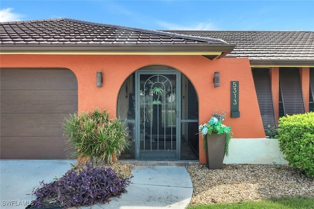 doorway to property with a garage