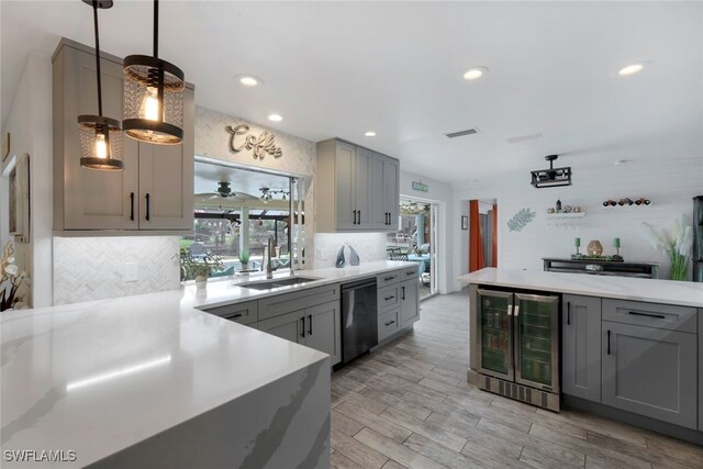 kitchen featuring gray cabinetry, pendant lighting, sink, wine cooler, and black dishwasher