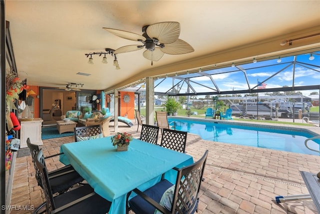 view of swimming pool with glass enclosure, a patio area, and an outdoor hangout area