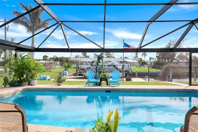 view of swimming pool featuring glass enclosure, a boat dock, and a patio