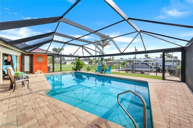 view of swimming pool featuring glass enclosure and a patio area