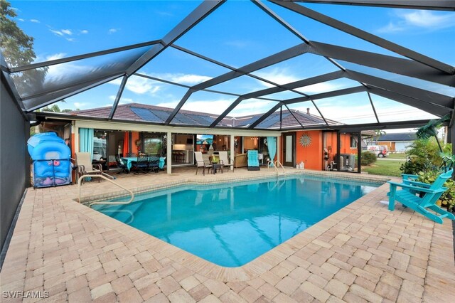 view of pool featuring a lanai and a patio