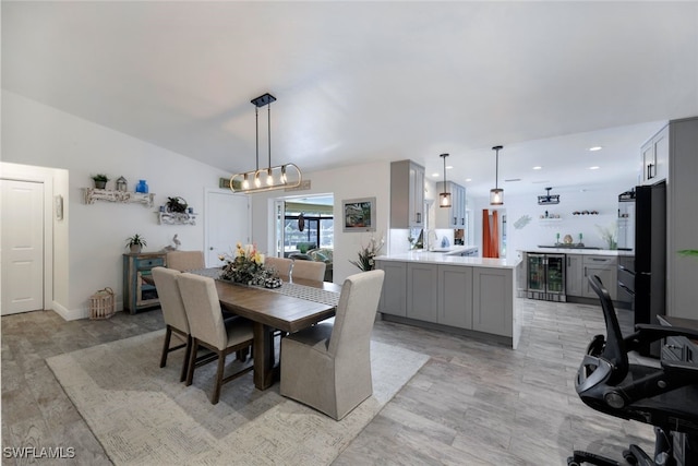 dining area featuring light hardwood / wood-style floors and beverage cooler