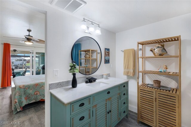 bathroom with hardwood / wood-style floors, ceiling fan, and vanity