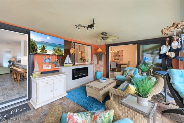 interior space featuring rail lighting and ceiling fan