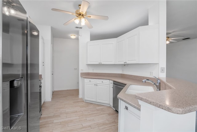 kitchen featuring kitchen peninsula, white cabinets, light wood-type flooring, sink, and stainless steel appliances