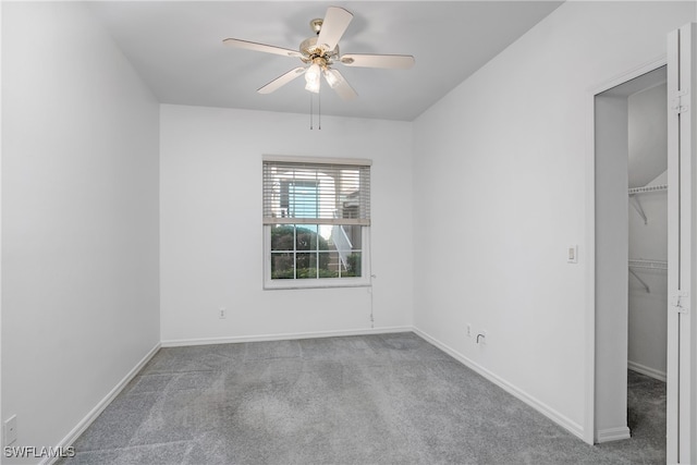 unfurnished room with light colored carpet and ceiling fan