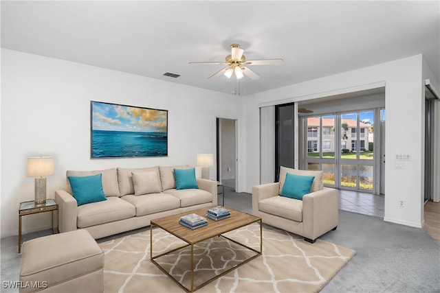 living room featuring carpet and ceiling fan