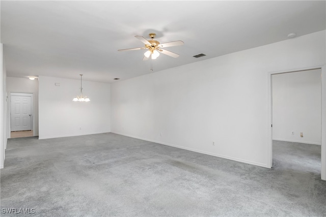 unfurnished room with carpet floors and ceiling fan with notable chandelier