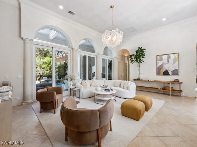 tiled living room featuring a notable chandelier, ornate columns, and crown molding