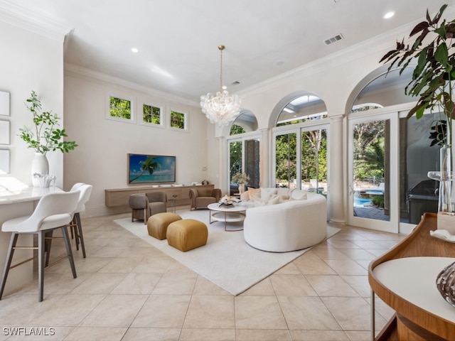 living room featuring an inviting chandelier, crown molding, and light tile patterned floors