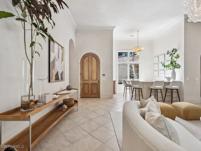 living room with ornamental molding and light tile patterned floors