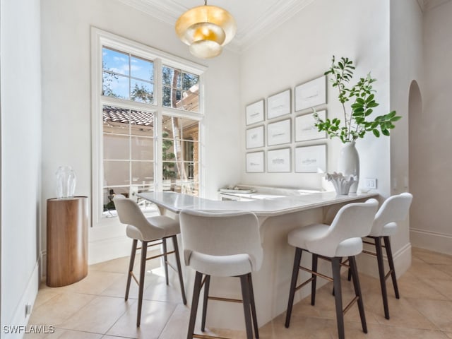 tiled dining room with crown molding