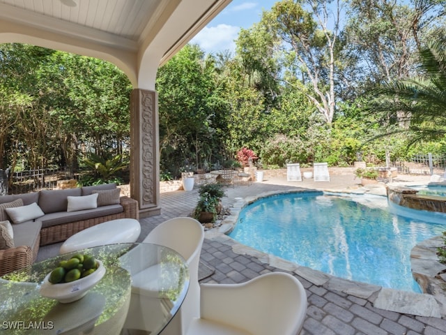 view of pool featuring an in ground hot tub, a patio area, and an outdoor living space