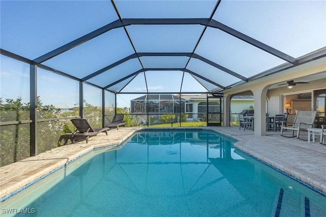 view of swimming pool with a lanai, a patio area, and ceiling fan