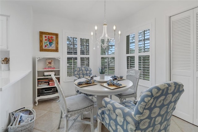 dining area with a notable chandelier and light tile patterned floors