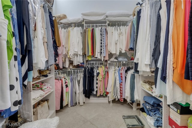 walk in closet with light tile patterned floors