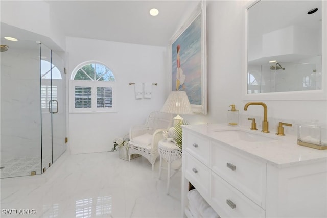 bathroom with marble finish floor, vanity, and a marble finish shower