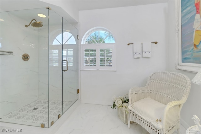 full bath with a marble finish shower and marble finish floor