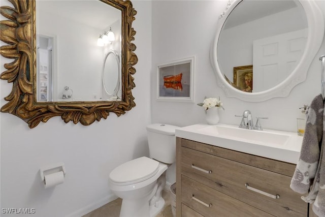 half bath featuring toilet and vanity