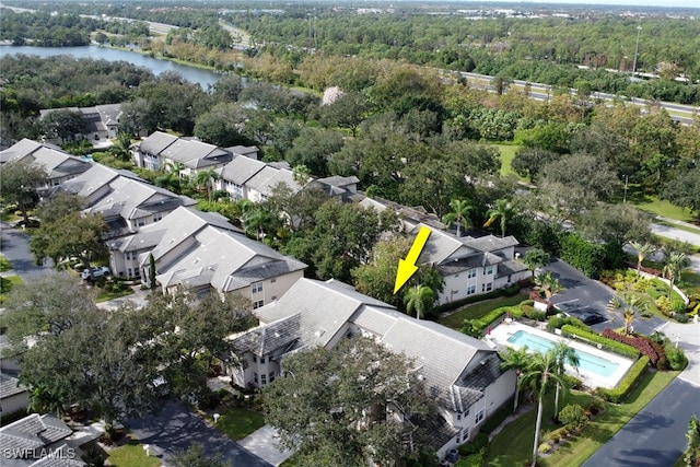bird's eye view with a residential view, a view of trees, and a water view