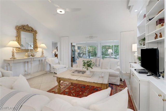 living area featuring light tile patterned flooring, vaulted ceiling, and ceiling fan